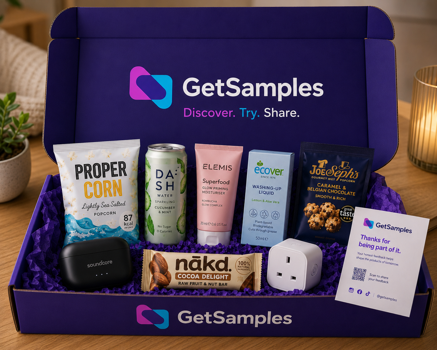 Open GetSamples discovery box with Proper Corn, Dash Water, Elemis Superfood, Ecover, Joe & Seph's caramel popcorn, Soundcore earbuds, Nakd bar and a smart plug.